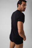 Hombre con el conjunto Guess de camiseta negra y bóxer trunk negro