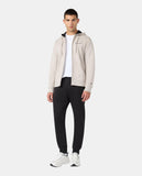 Chándal Champion beige y negro para hombre, vista frontal del conjunto puesto